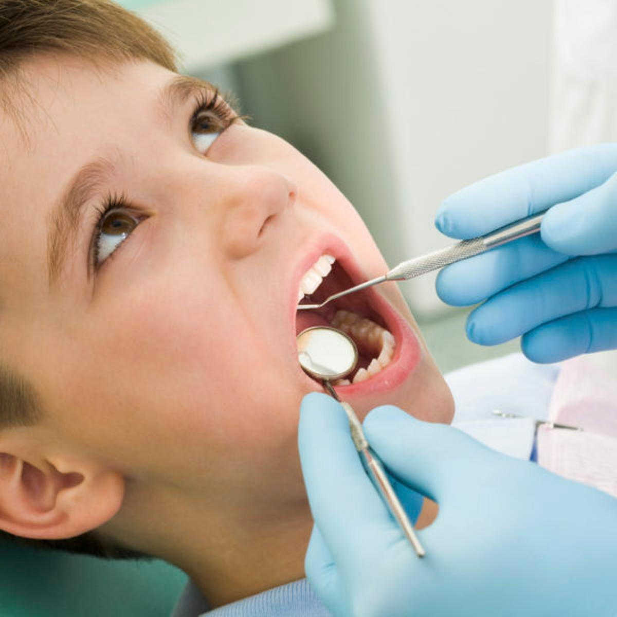 Photo of young happy boy having a dental exam